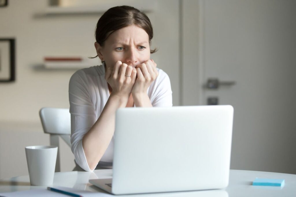Person looking at a laptop screen.