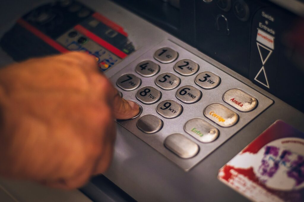 person holding white and red card; switching banks