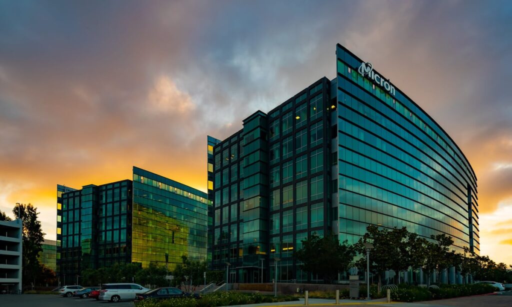 Micron building at night with micron logo on top.