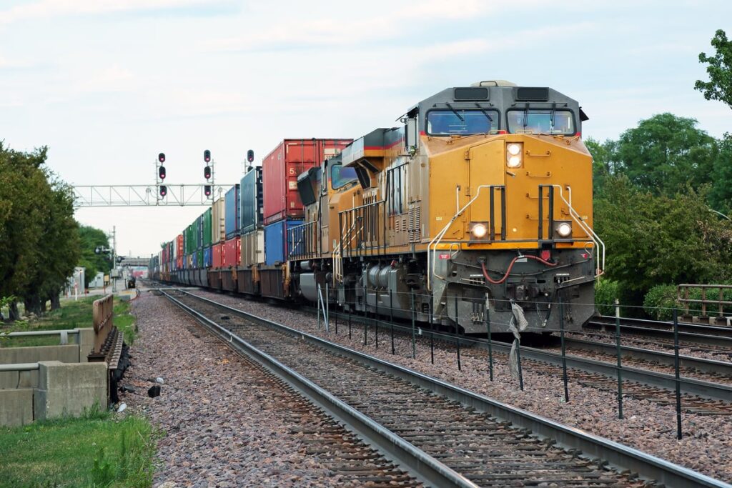 A railroad train is transporting freight.