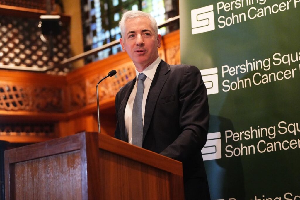 Bill Ackman speaks at a podium with Pershing Square signage behind him.