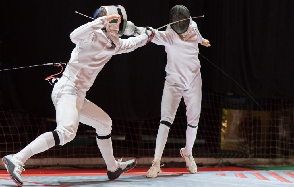 Two College Students Fencing Athletes