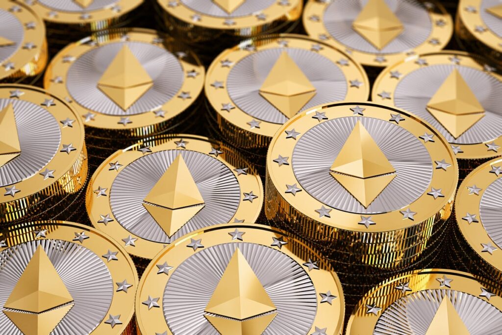 A pile of coins _embossed with the Ethereum logo.