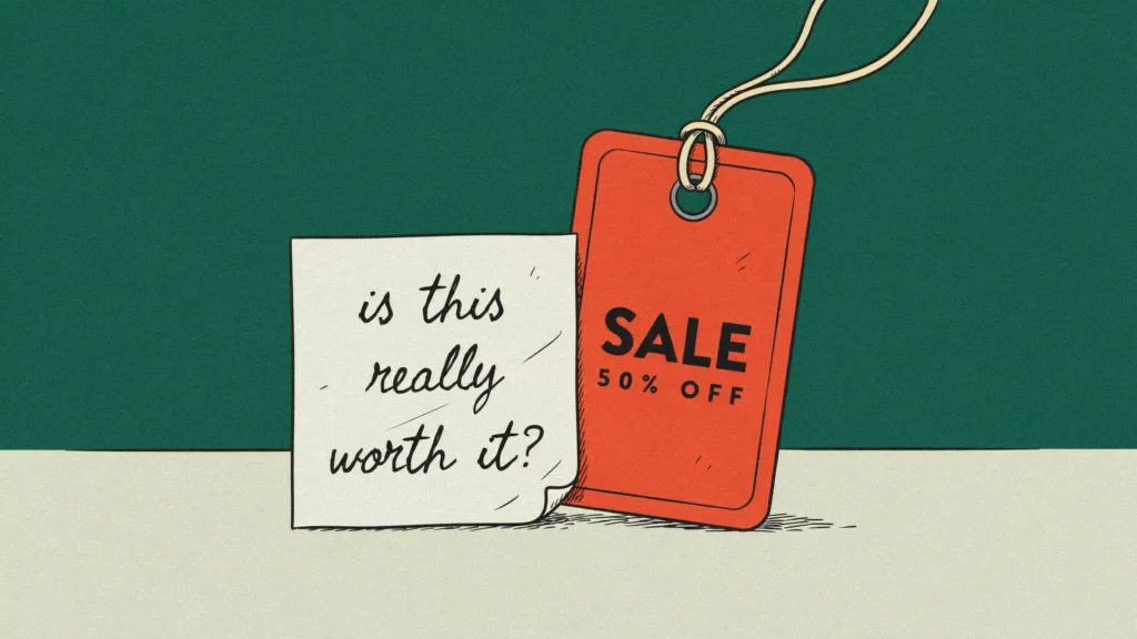 A small creased handwritten slip pinned beside a large glossy orange retail swing tag on pale linen.