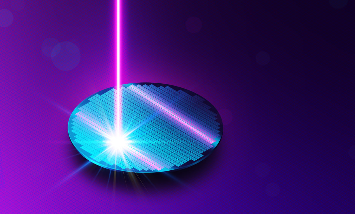 A beam of light imprinting on a semiconductor wafer.