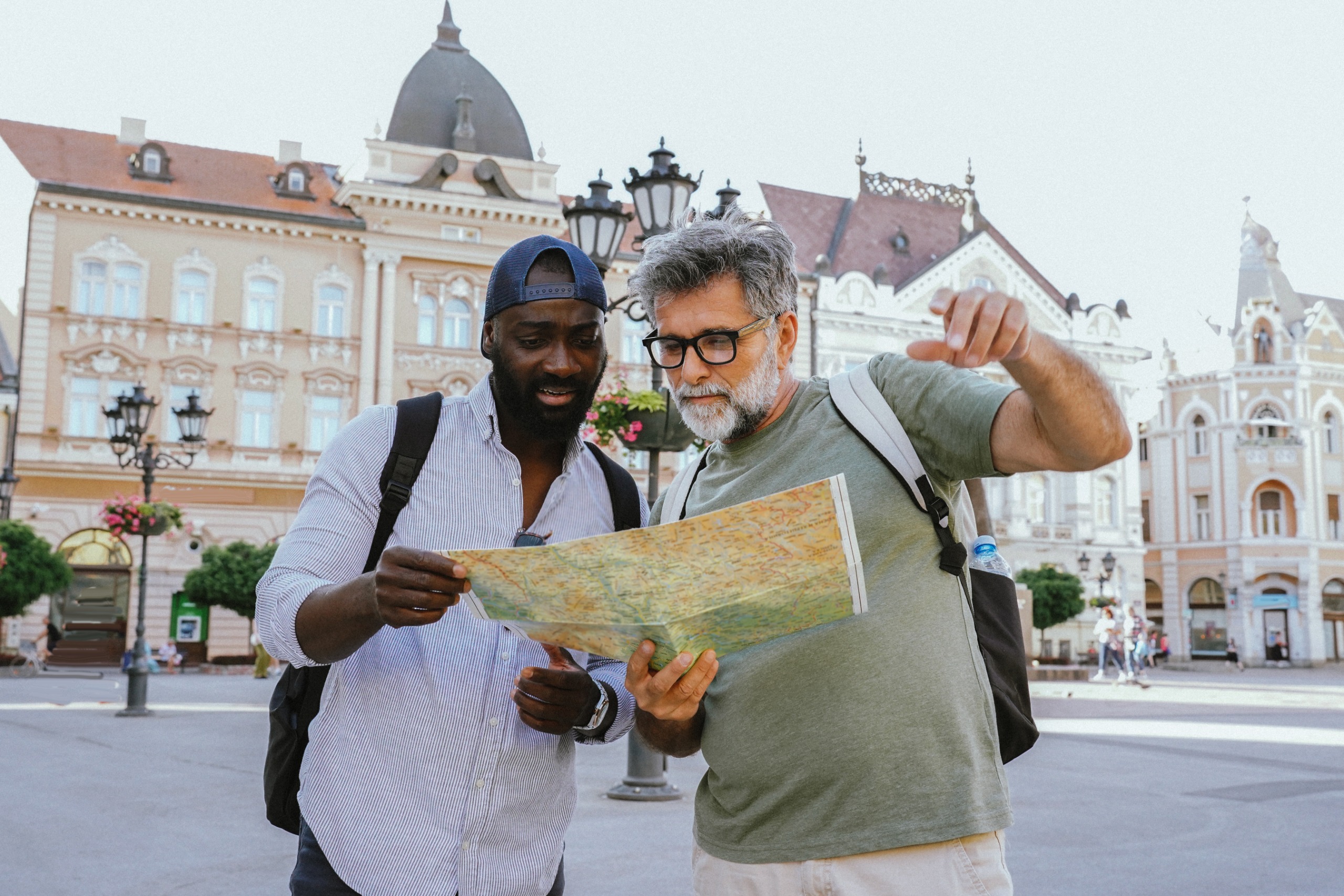 A lost tourist asks a local for help locating his destination on a map.