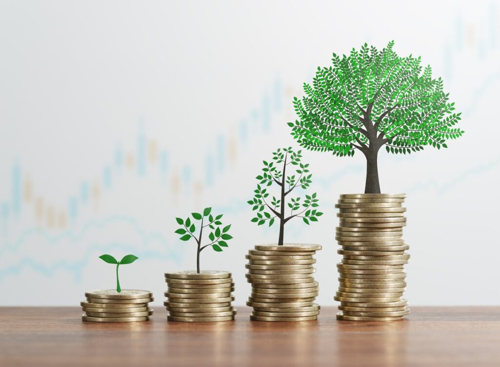 Stacks of gold coins with trees growing on top.