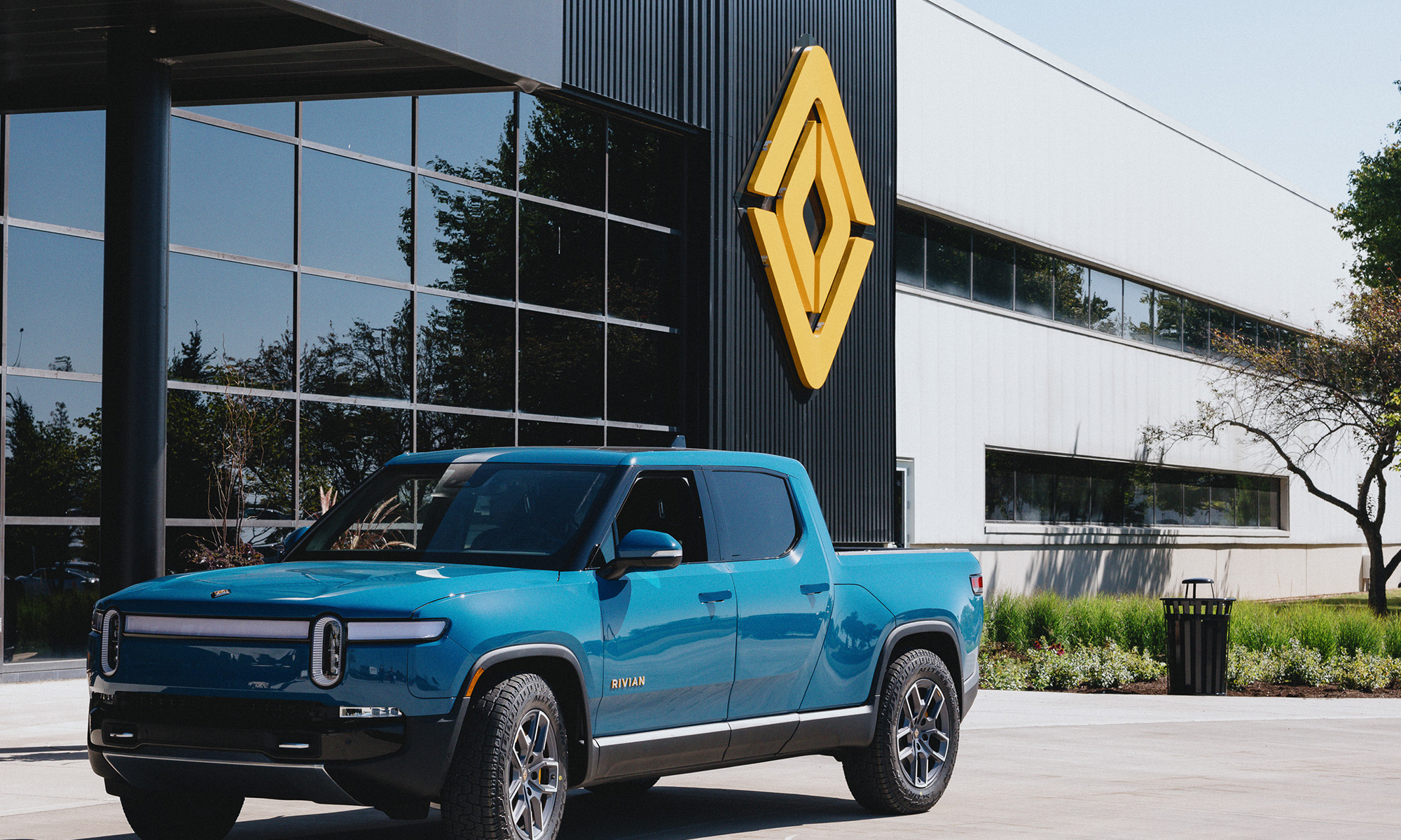 Rivian pickup truck parked in front of headquarters.