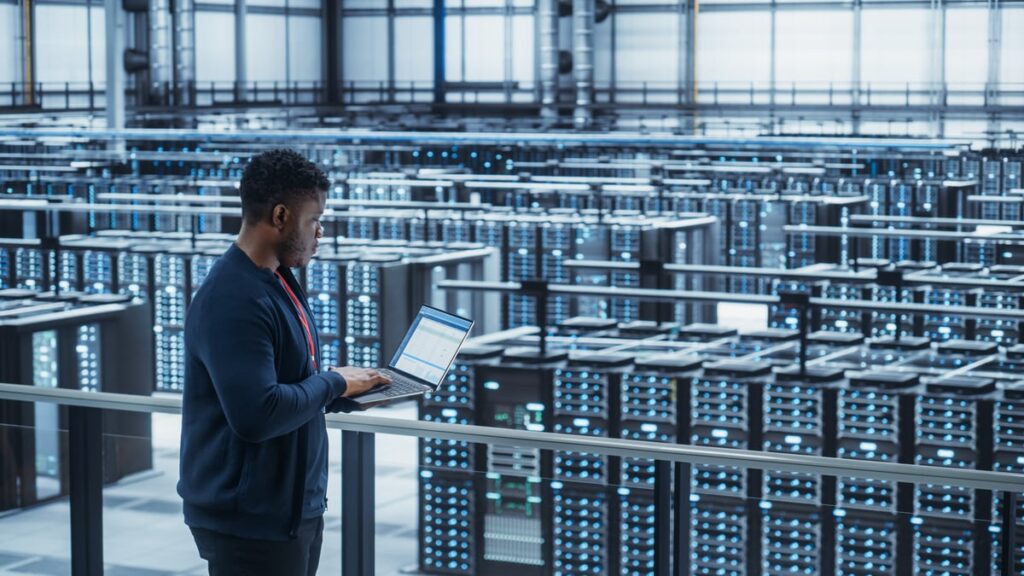 Tech overlooking a data center.