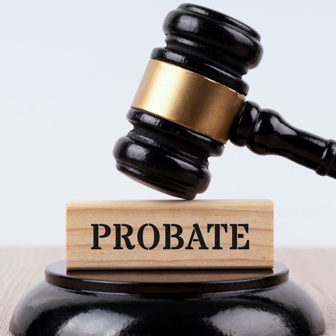 A gavel on top of a block with the word probate on it.