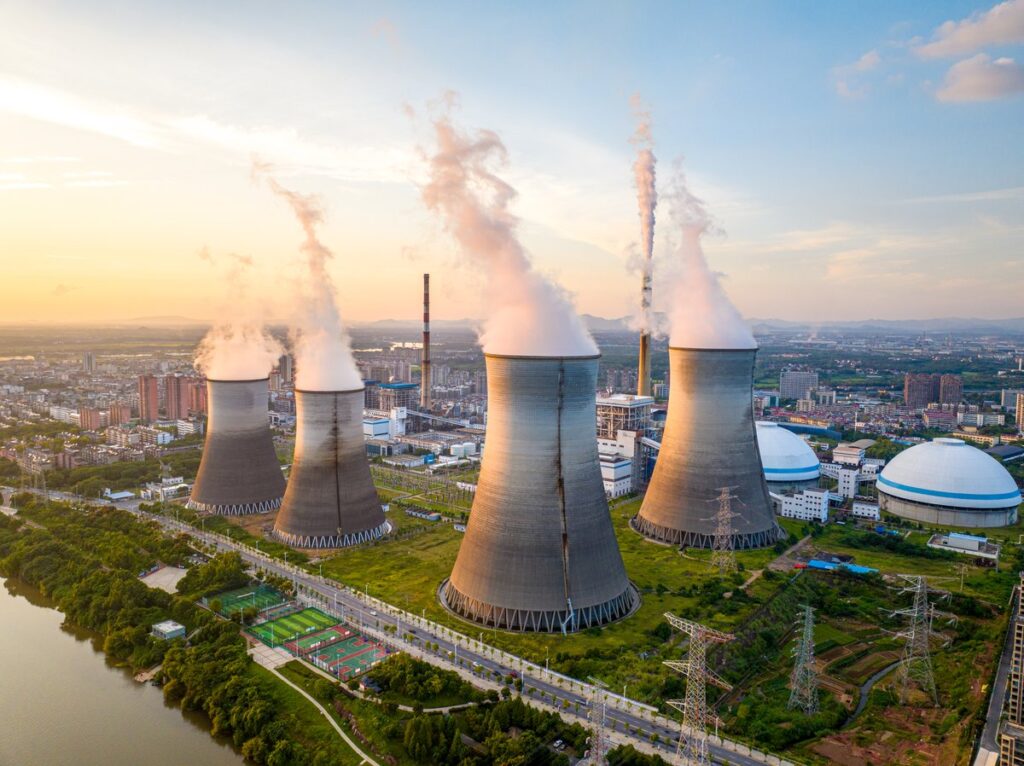 Image shows several cooling towers at a power generation facility.